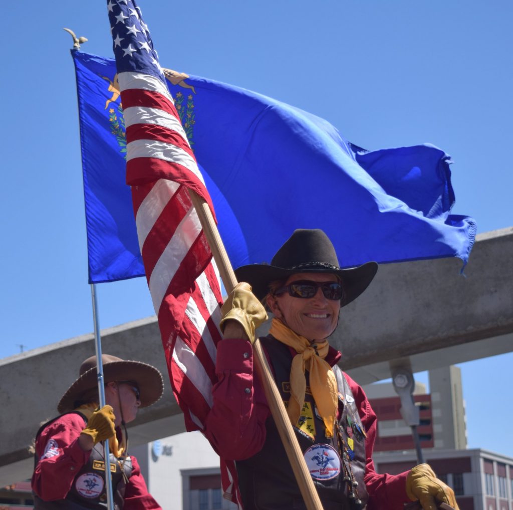 woman pony express rider carrying an American flag